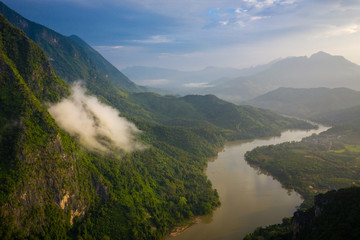 Naklejka na ściany i meble Aerial view of mountains and river Nong Khiaw. North Laos. Southeast Asia. Photo made by drone from above. Bird eye view.