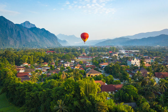 Hot air balloon over Nam Song river at sunrise in Vang vieng, Laos. Asia.