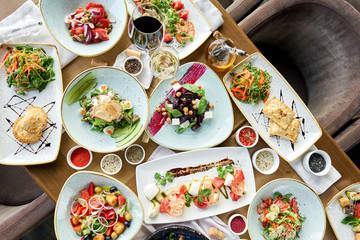 Variety of dishes on the table. Various snacks and antipasti on the table. Restaurant menu. Italian cuisine