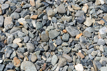 Black small road stone background, dark gravel pebbles stone texture, granite,marble