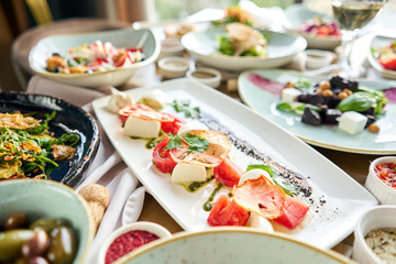 Variety of dishes on the table. Various snacks and antipasti on the table. Restaurant menu. Italian cuisine