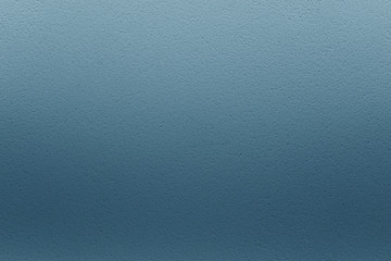 Blue gradient background. Stucco on the wall.
