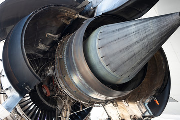 Gas turbine engine close up during maintenance when airplane park at the airport.Mechanic and...