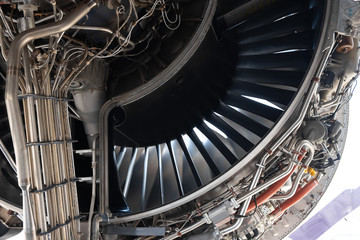 Gas turbine engine close up during maintenance when airplane park at the airport.Mechanic and...