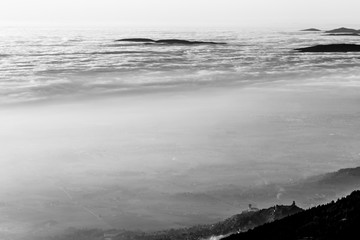 A view from above of Assisi town (Umbria, Italy) in the middle of mist