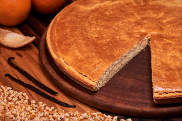 Homemade Italian Ricotta Cheesecake with chopped candied orange peels on wooden background.
