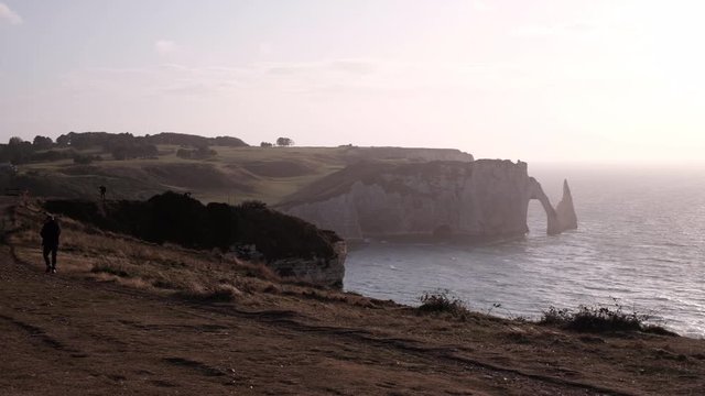 The small old chapel in Etretat on the top of the cliff fronting the big ocean. View of the beautiful coastline and alabaster cliff of Etretat, Normandie, France