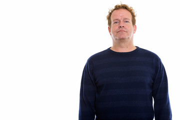 Fototapeta premium Studio shot of mature man with curly blond hair isolated against white background