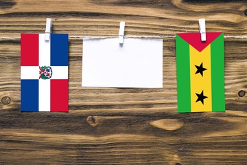 Hanging flags of Dominican Republic and Sao Tome And Principe attached to rope with clothes pins...