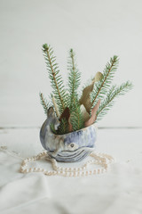 Christmas decorative composition with whale, spruce branches and pearls.