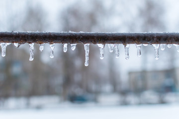 icicles on a metal crossbar
