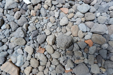 Detail of surface texture with small pebble rock on dirty ground.Texture of concrete floor in at car park. Surface grooved vertical pattern, Rough and rugged on street,Grey color, Wallpaper background