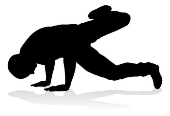 Obraz premium A male street dance hip hop dancer in silhouette