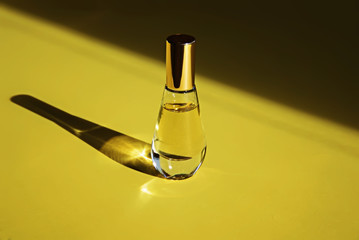 Perfume bottle on yellow background