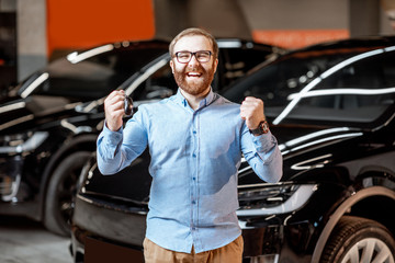 Portrait of a man near electric car at the showroom