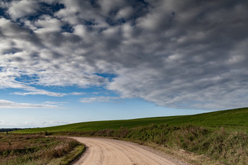 Gravel road in countryside landscape.