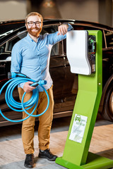 Man choosing car charger at the car dealership