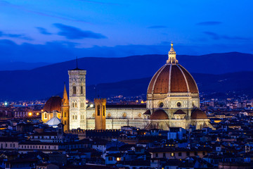 Fototapeta na wymiar The Duomo (Cathedral of Santa Maria del Fiore) Rising Above the City at Night, Florence, Italy
