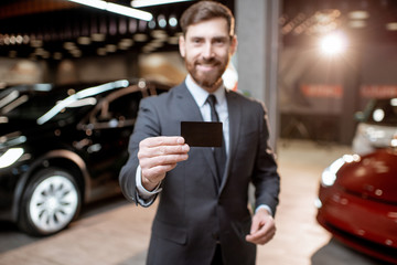 Salesman with key at the car dealership