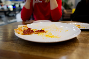 What a delicious pizza was, there was the last piece of pepperoni on a white plate