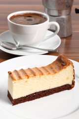 Cheesecake and coffee cup. Macro.