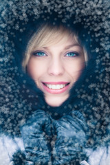 Winter portrait of a beautiful woman with snowflakes