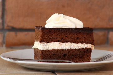 Chocolate Sponge Cake filled with whipped cream. Cream Pie.