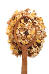 Muesli with dried fruits on wooden spoon. Isolated on white background. Directly Above.