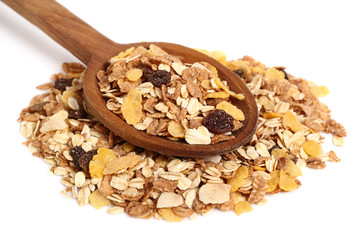 Muesli with dried fruits on wooden spoon. Isolated on white background.