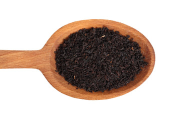 Loose dried black tea leaves on wooden spoon. Isolated on white background. Directly Above.