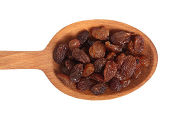 Raisins on wooden spoon. Isolated on white background. Directly Above.