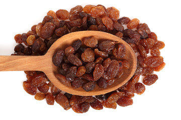 Raisins on wooden spoon. Isolated on white background. Directly Above.