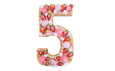 beautiful homemade birthday cake in the form of the number five on a red substrate top view . Strawberry cake . birthday cake in the shape of the number five on a white background .