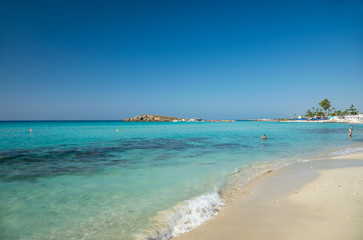Fototapeta premium The most famous beach of Cyprus with crystal clear water. Nissi Beach.