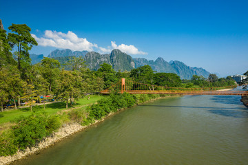 Aerial view of village Vang Vieng and  Nam Song river , Laos. Southeast Asia. Photo made by drone from above. Bird eye view.