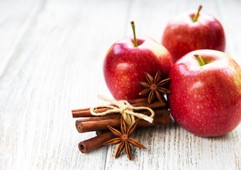 Red apples with cinnamon sticks and anise