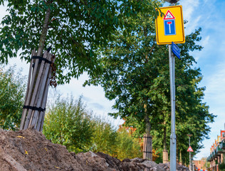 Caution signs. Warning signs and fencing construction.Repair work 