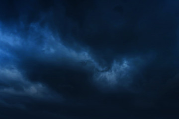 Obraz premium A of the large dark tone sunset as the massive sun sets into the horizon above the ocean, Sunset sky clouds. Sunset sky background. Sunset sky blue.at phuket,Dark, black sky is causing a thunderstorm.