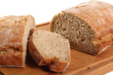 Loaf of rye bread on cutting board. Isolated with clipping path.