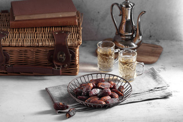 dates fruit and Arab tea on a white concrete background with a blank space for a text, dates fruit on a white background