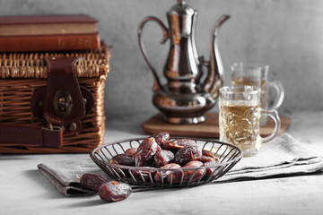 dates fruit and Arab tea on a white concrete background with a blank space for a text, dates fruit on a white background