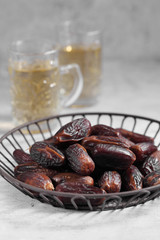 dates fruit and Arab tea on a white concrete background with a blank space for a text, dates fruit on a white background