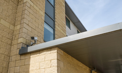 CCTV security camera seen pointing towards the entrance area of a well-known UK hotel chain, with...