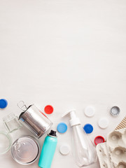 Flat lay of different wastes wastes ready for recycling. Plastic, glass, paper, tin cans