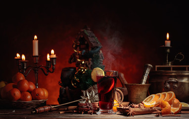 Mulled wine and Christmas decorations with candlesticks.