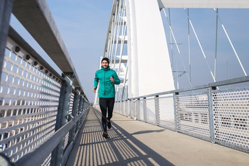 Young man running outdoors in morning