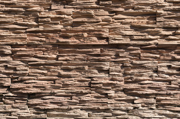 Abstract beige brown slate pattern stone block wall texture for background and wallpaper large and wide modern stone wall facade