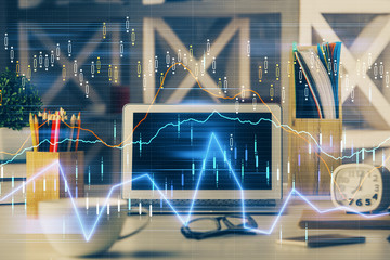Double exposure of graph and financial info and work space with computer background. Concept of...