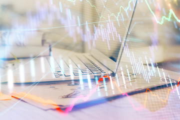 Forex Chart hologram on table with computer background. Multi exposure. Concept of financial markets.
