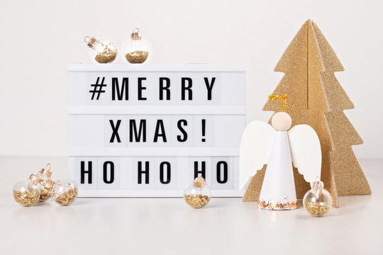 Christmas greeting card mock up. Light box with the text Merry Xmas and Christmas decoration